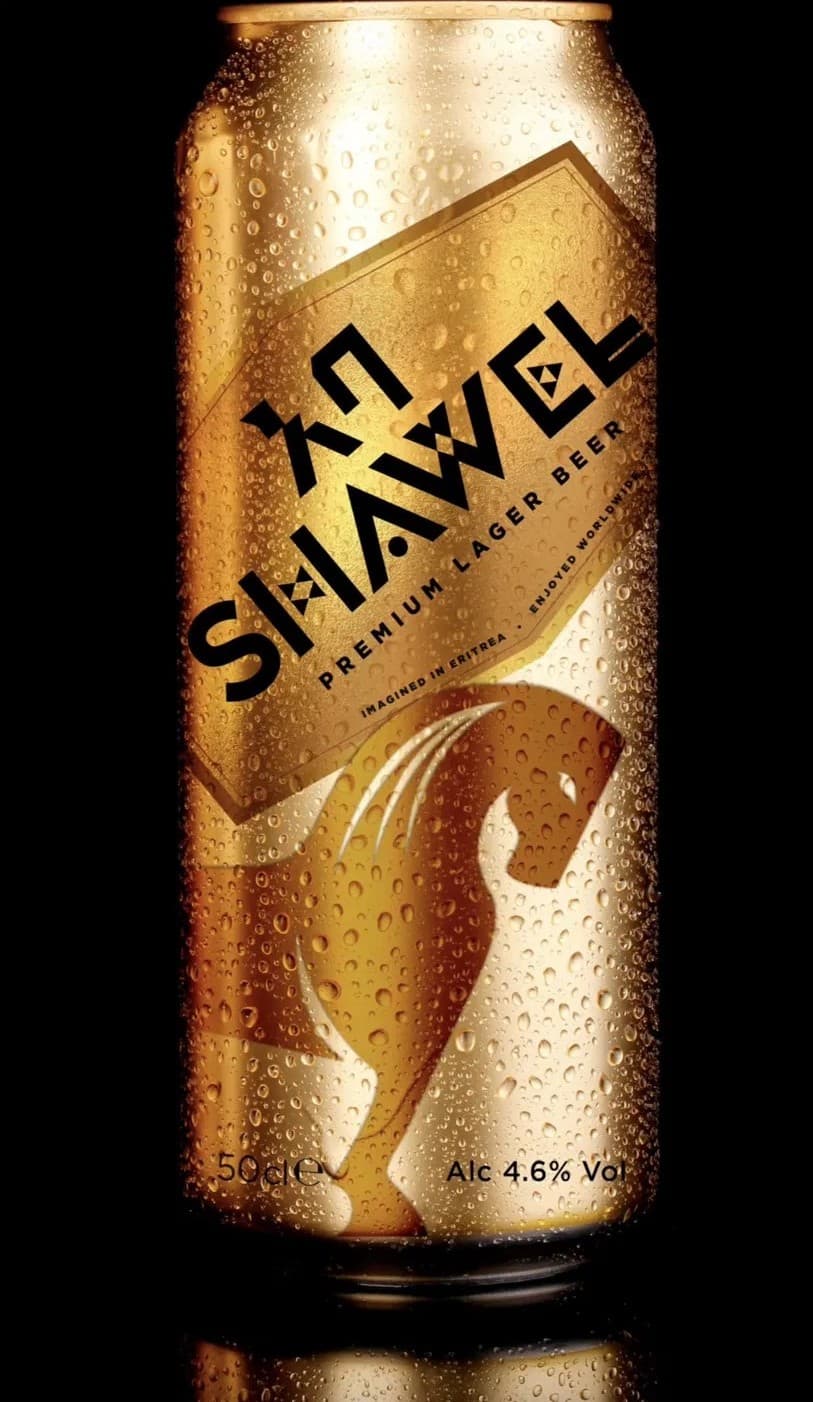 A tall gold Shawel Premium Lager can, beaded with condensation