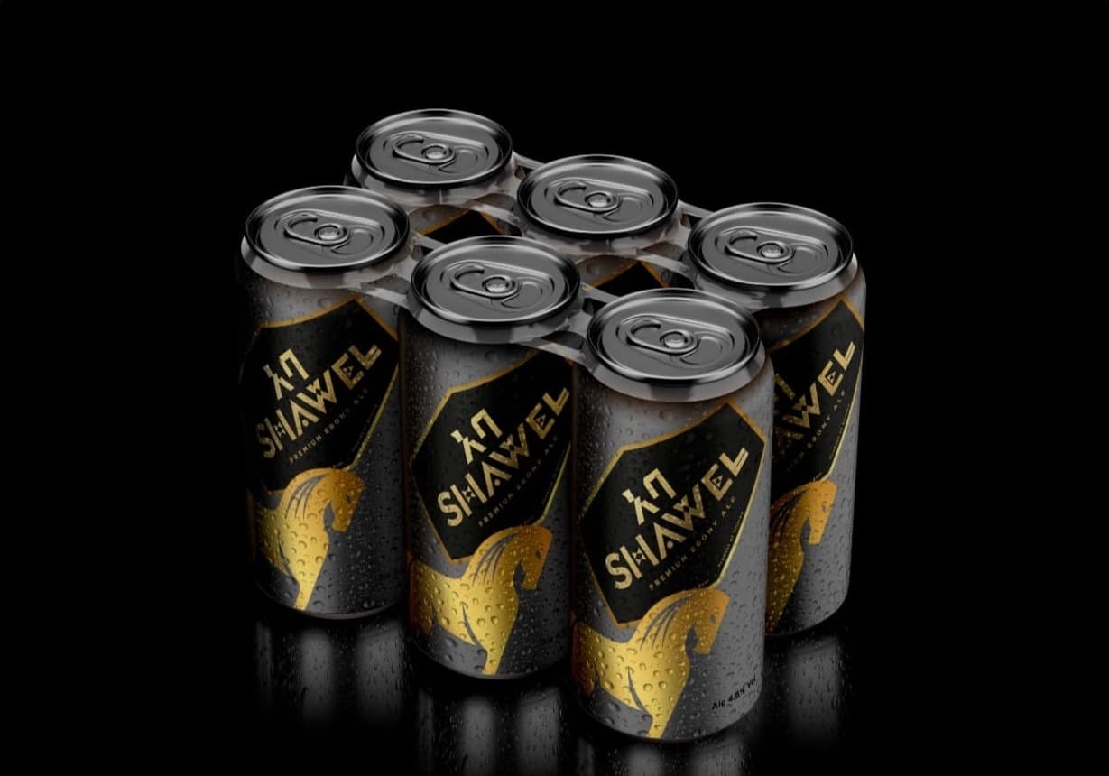 A six-pack of black Shawel cans with the gold horse