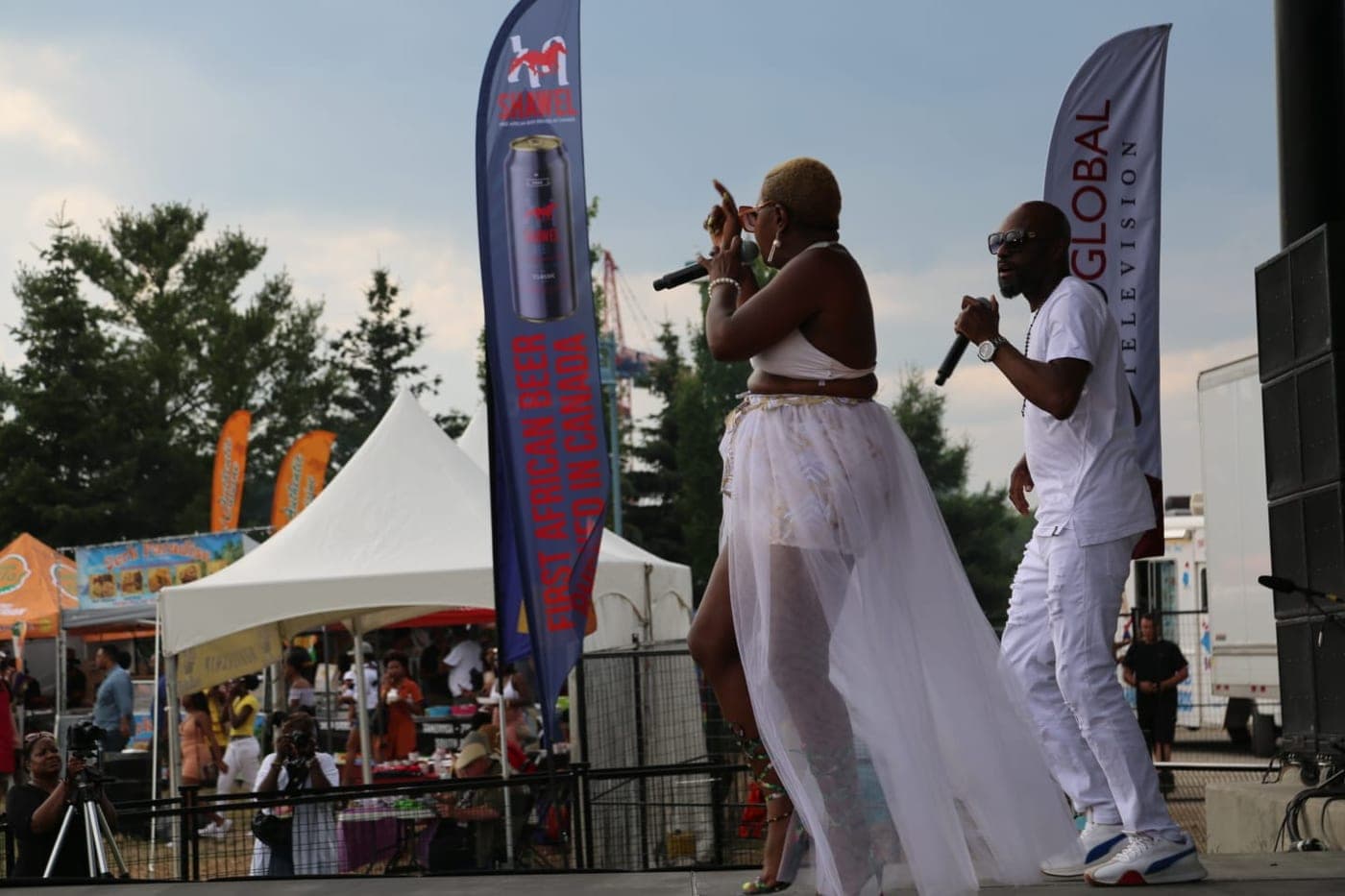 A performer on stage beside Shawel banners